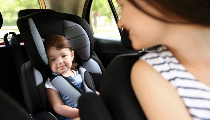 Mother and child in car. Safety driving concept