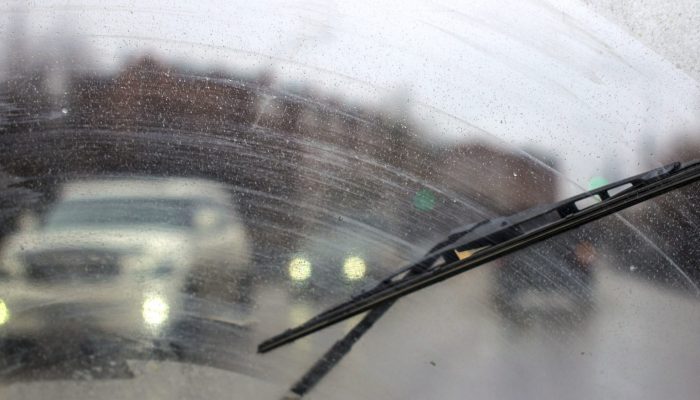 Windshield wipers from inside of car, season rain.
